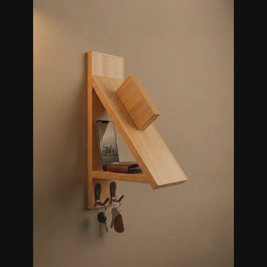 Wall-mounted wooden motorcycle helmet rack with integrated key hooks.
