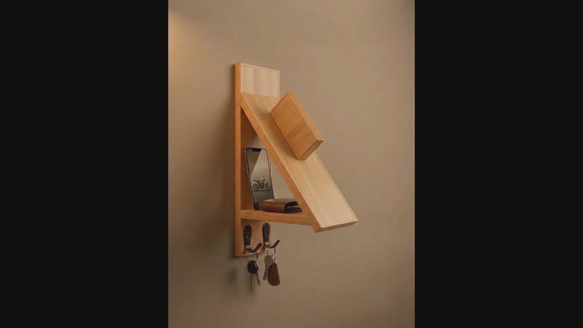 Wall-mounted wooden motorcycle helmet rack with integrated key hooks.