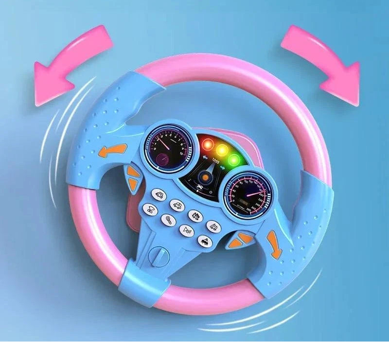 Promotional banner for the pastel pink and blue multifunctional simulation steering wheel toy, displayed against a bright blue sky background with clouds and a mini toy car on a road graphic.