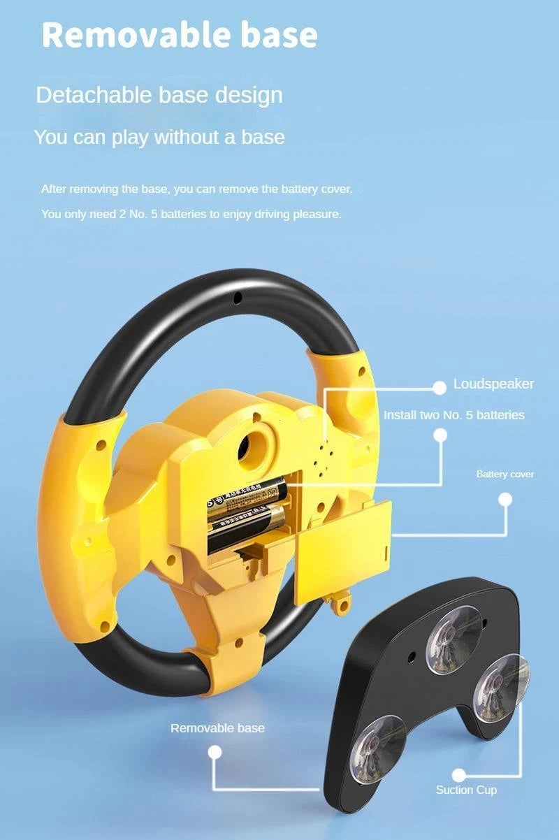 Rear-view blueprint style diagram of the yellow toddler driving toy showing the loudspeaker placement, open battery compartment layout for two AA batteries, and the detachable suction cup base.
