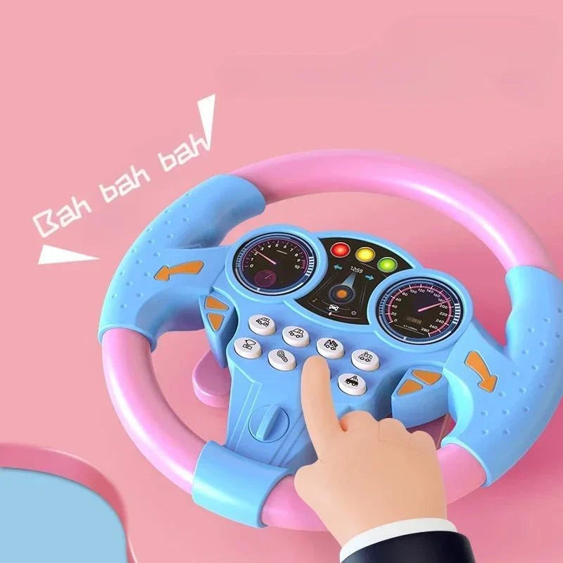 Bright pink and sky blue musical steering wheel toy for babies and toddlers featuring realistic vehicle sound buttons, faux speedometers, and a glowing light-up dashboard display.